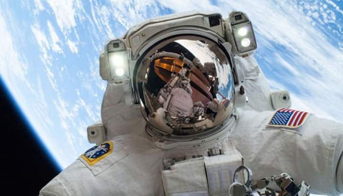 Scott Kelly completes first spacewalk, sets US flight record