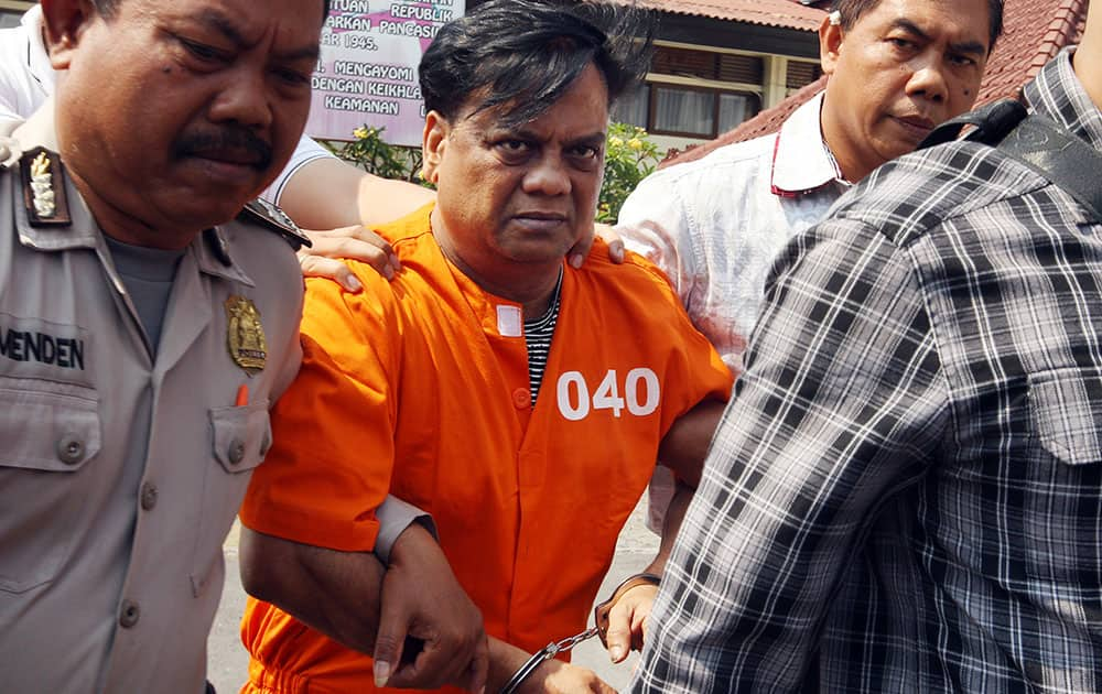 Rajendra Sadashiv Nikalje, known in India as 'Chotta Rajan,', is escorted by plain-clothed police officers for questioning in Bali, Indonesia.