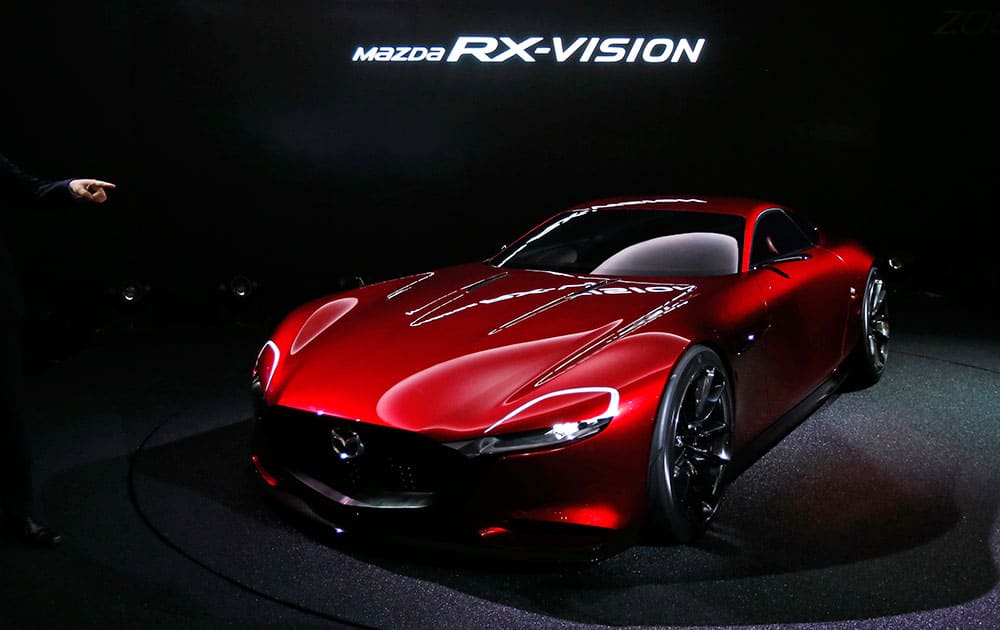 A visitor points a Mazda RX-Vision concept unveiled at the media preview of the Tokyo Motor Show in Tokyo.