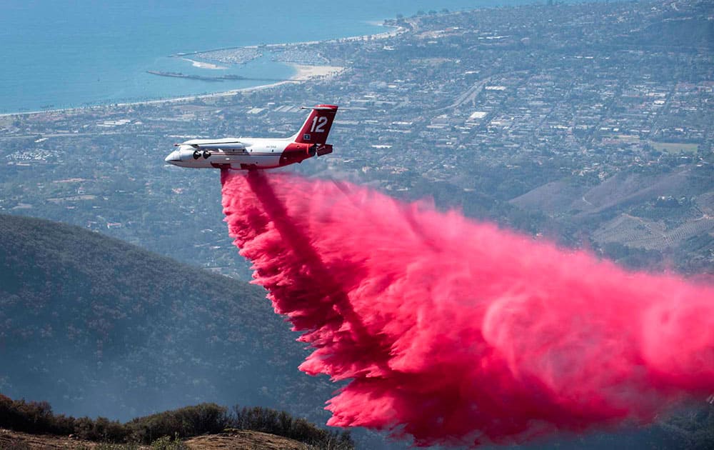 A plane makes first drop of fire retardant on a wild fire near Santa Barbara, Calif.