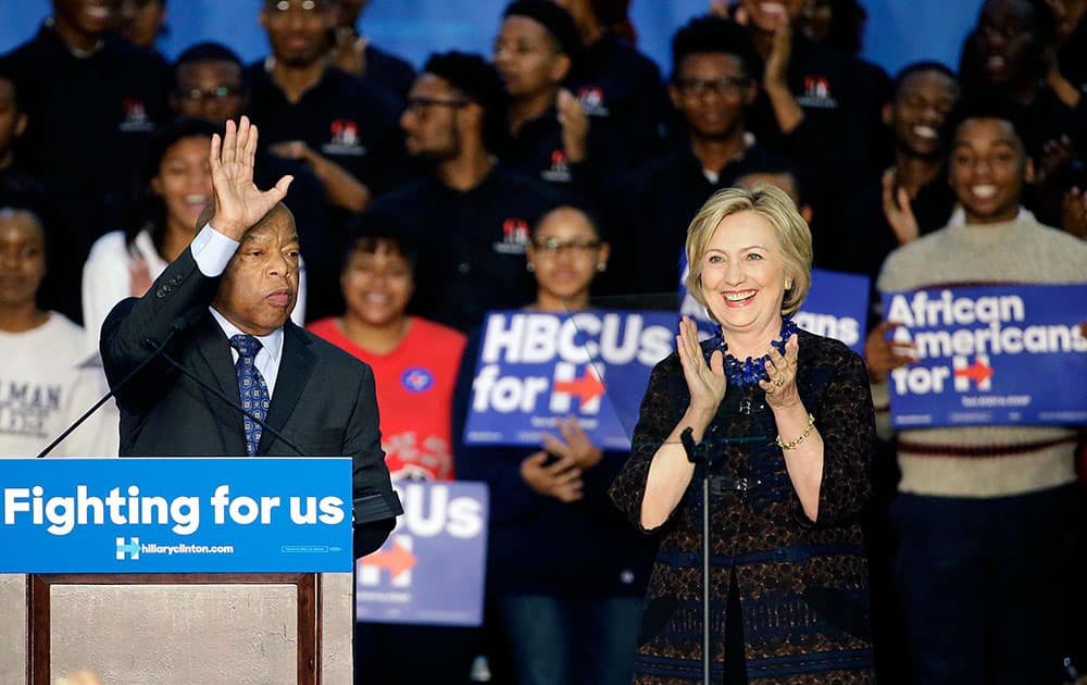 Democratic presidential candidate Hillary Rodham Clinton, right, and Rep. John Lewis, D-Ga., step onstage during a campaign event for Clinton at Clark Atlanta University.