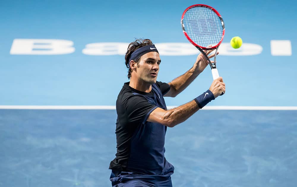 Switzerland's Roger Federer returns a ball to Belgium’s David Goffin during their quarter final match of the Swiss Indoors tennis tournament at the St. Jakobshalle in Basel, Switzerland.