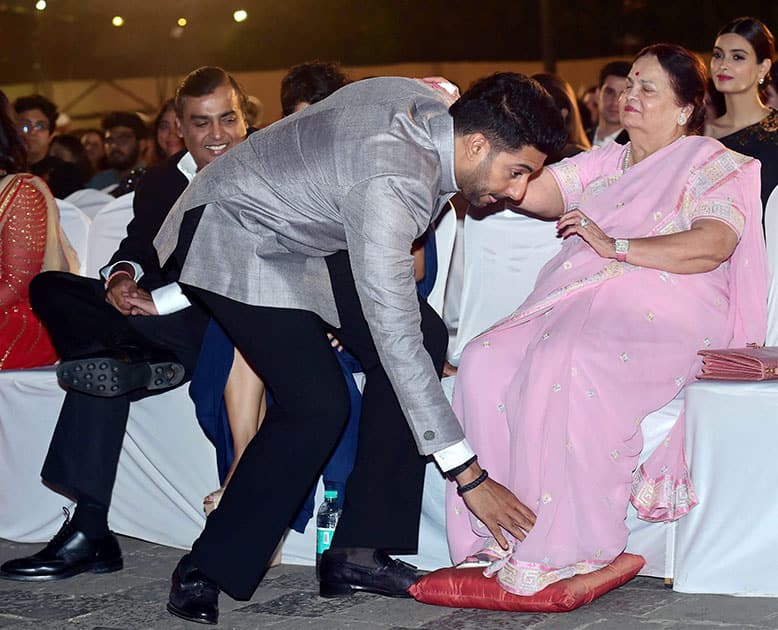 Industrialist Mukesh Ambani looks on as actor Abhishek Bachchan seeks blessing from Kokilaben Ambani during opening ceremony of 17th edition of Jio MAMI Mumbai Film Festival.