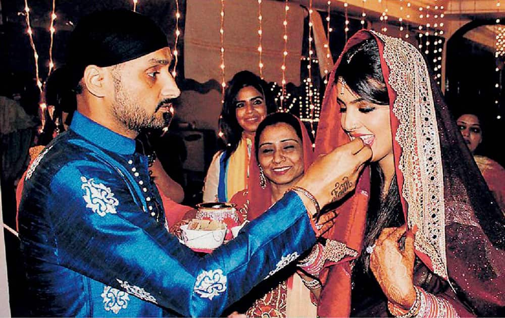 Cricketer Harbajan Singh along with his wife during Karva Chauth celebrations, in Jalandhar.