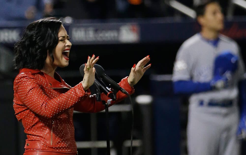 Demi Lovato sings the national anthem before Game 4 of the Major League Baseball World Series between the New York Mets and Kansas City Royals in New York.