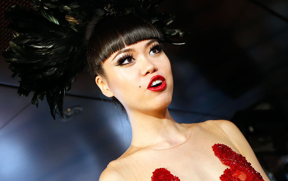 Jessica Minh Anh poses backstage prior to the Jessica Minh Anh Autumn Fashion Show on a floating catwalk set up in a boat cruising on the Seine river, in Paris.