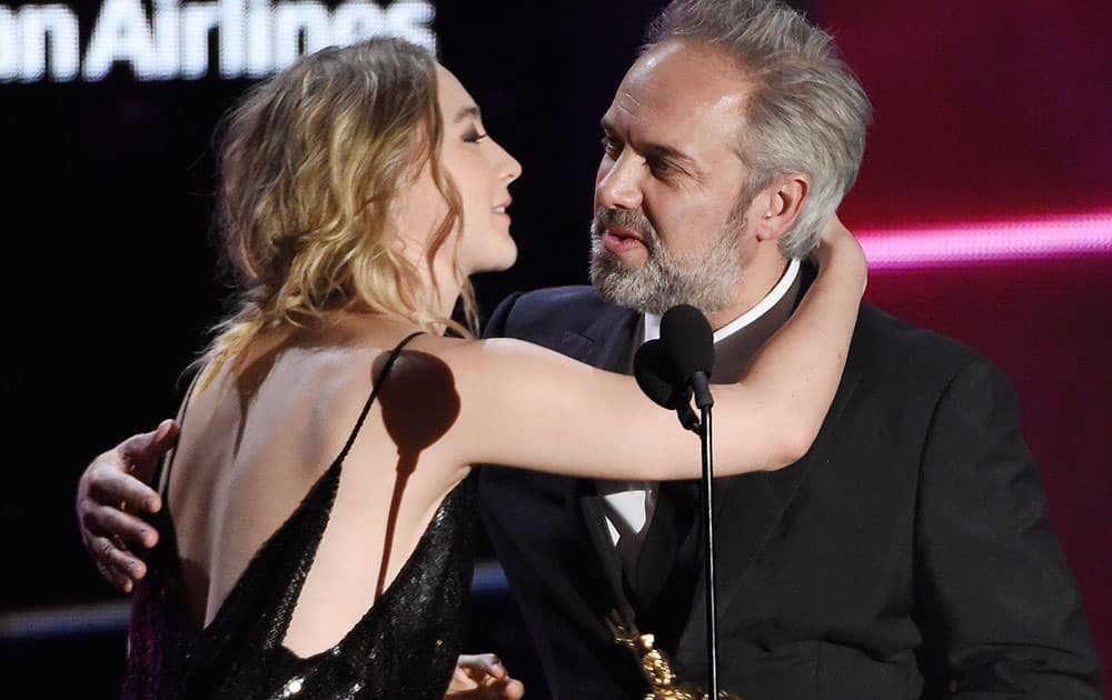 Director Sam Mendes accepts the John Schlesinger Britannia Award for Excellence in Directing from actress Saoirse Ronan at the BAFTA Los Angeles Britannia Awards at the Beverly Hilton.