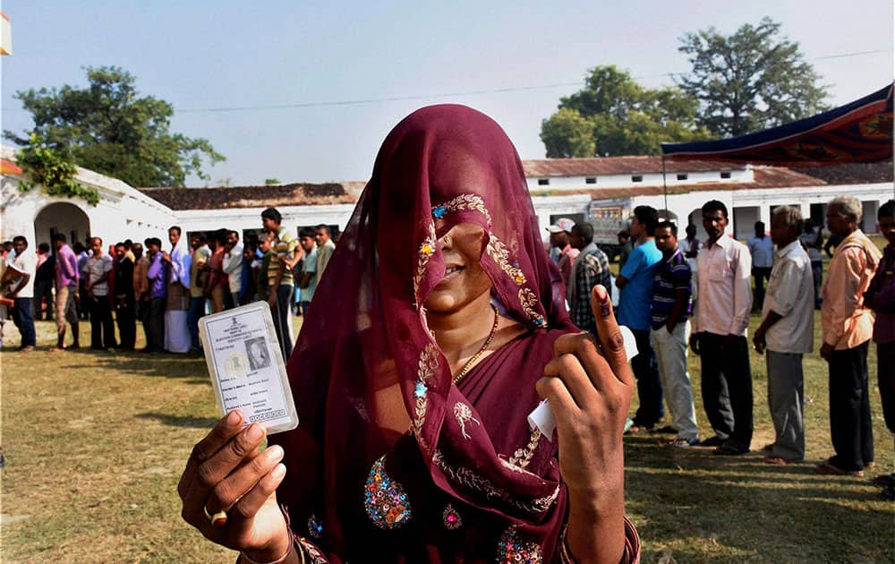 A voter shows her inked finger after casting vote during fourth phase of Bihar elections in Muzaffarpur.
