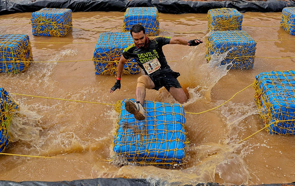 A participant loses his balance while attempting to cross an obstacle during Devils Circuit, an obstacle run event in Bangalore.