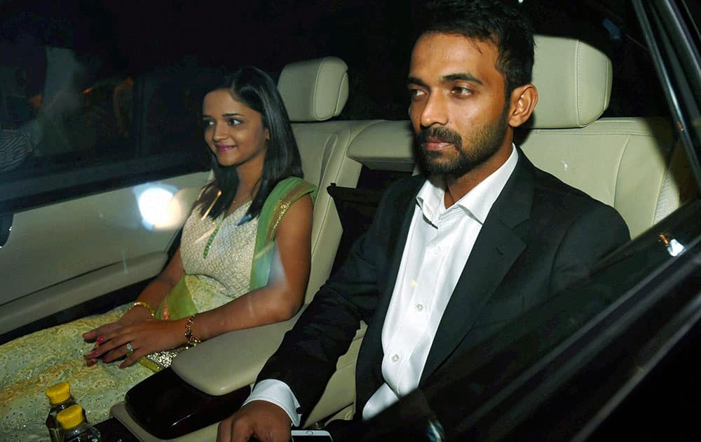 Cricketer Ajinkya Rehane with his wife arrives to attend wedding reception of Harbhajan Singh and Geeta Basra in New Delhi.