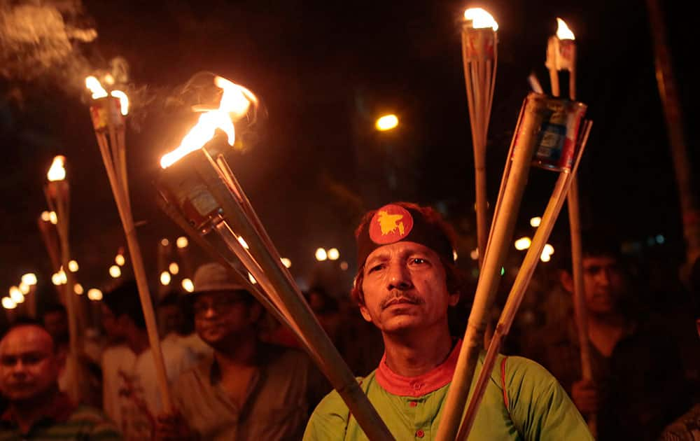 Bangladeshi activists, writers and publishers participate in a torch rally held to protest against the killing of Faisal Arefin Deepan, a publisher of secular books, and the attacks on the other publishers and bloggers in Dhaka, Bangladesh.