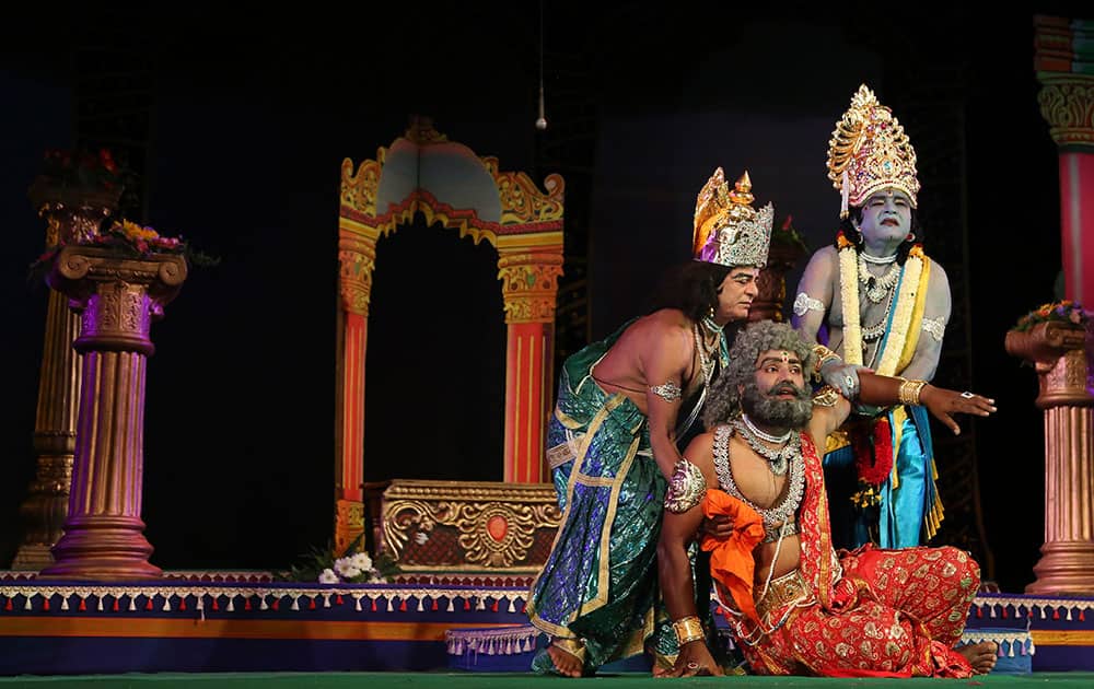 Actors dressed as Rama, Dasharatha and Laxman, the characters of Hindu epic Ramayana perform at a theatre in Bangalore.