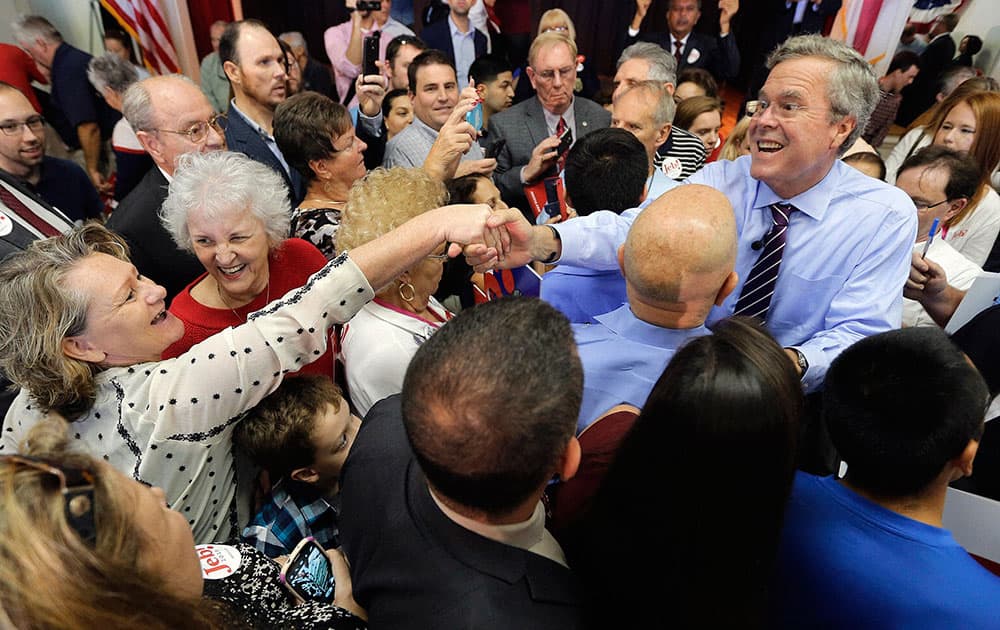 Republican presidential candidate, former Florida Gov. Jeb Bush, reaches into the crowd as he greets supporters after a rally.