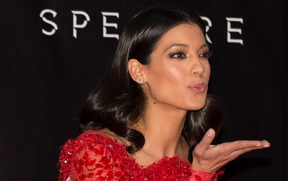 Actress Stephanie Sigman blows a kiss toward photographers as she walks the red carpet at the regional premiere of the latest James Bond film, 