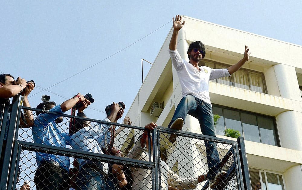 Bollywood actor Shahrukh Khan addresses his fans on his 50th birthday celebration outside his residence, Mannat in Mumbai.