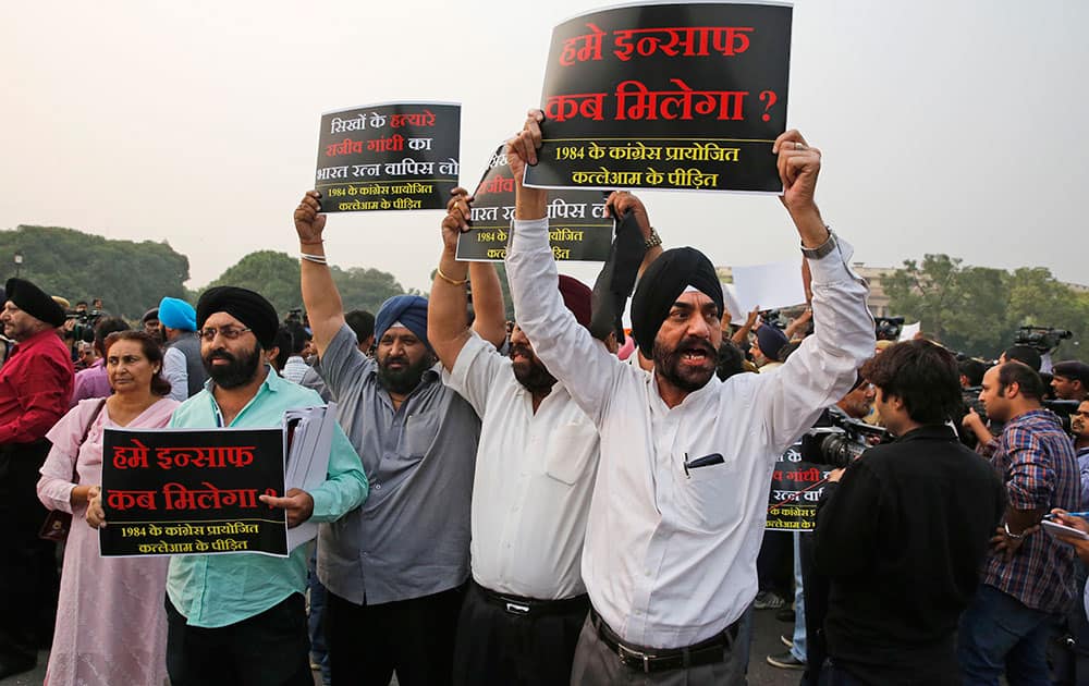 A group of Sikhs shout slogans demanding justice for 1984 sikhs riots victims just before Congress party leaders marched to the Presidential Palace, in New Delhi.