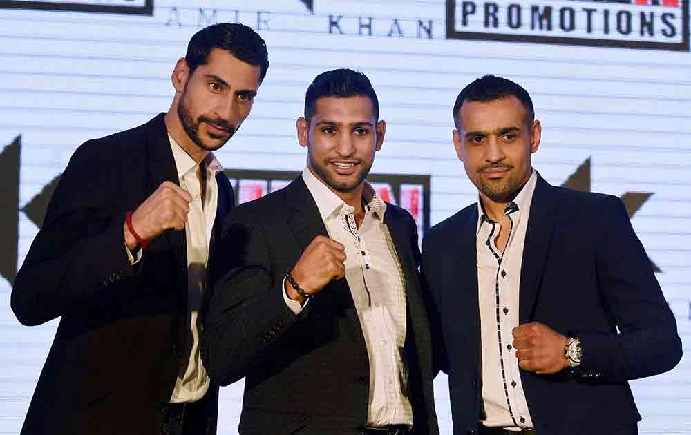 British pro boxer Amir Khan with Bill Dosanjh (r) CEO Super Fight Promotions during a press conference in New Delhi.