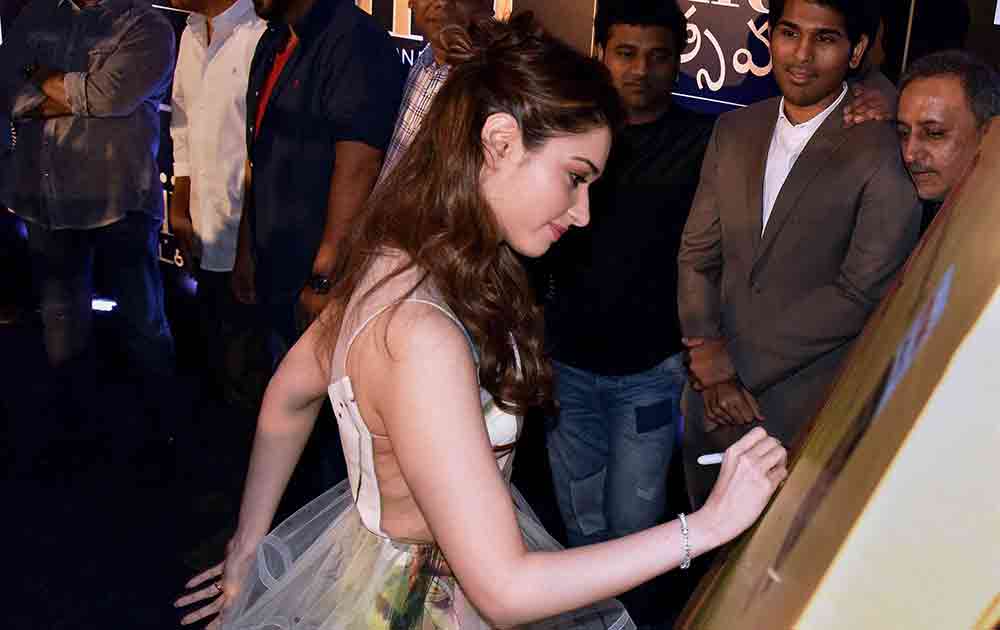 Actress Tamanna Bhatia signs during the launch of The International Indian Film Academy Awards (IIFA) in Hyderabad.
