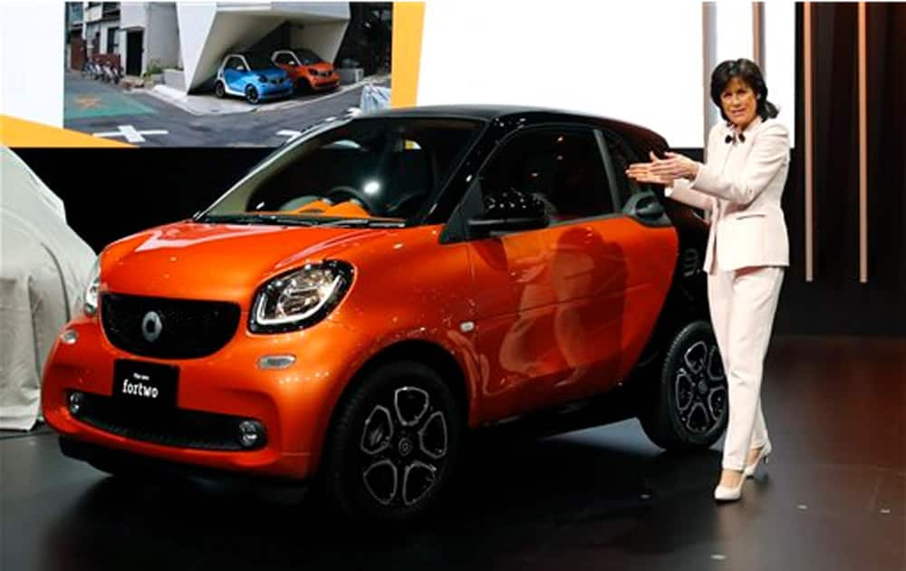 Smart Automobile CEO and Director Annette Winkler unveils new vehicle Smart fortwo during the media preview for the Tokyo Motor Show in Tokyo, Wednesday, Oct. 28, 2015.
