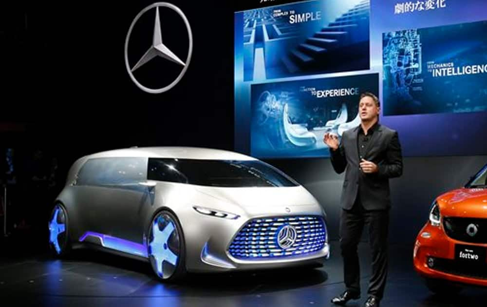 Daimler AG head of design Gorden Wagener unveils their concept car Vision Tokyo, left, at the media preview of the Tokyo Motor Show in Tokyo Wednesday, Oct. 28, 2015. 
