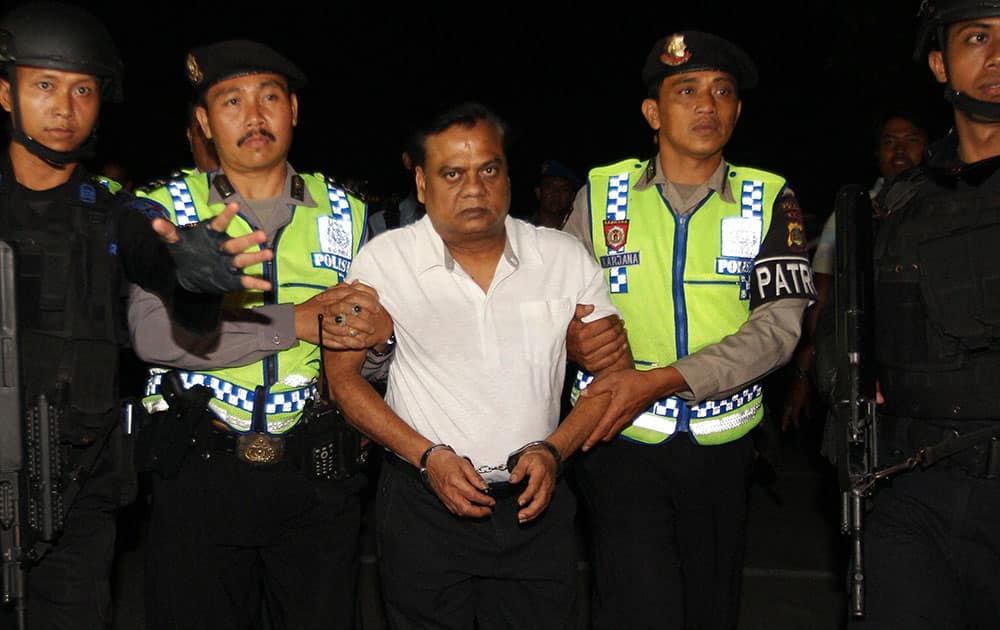 Indian fugitive Rajendra Sadashiv Nikalje, known in India as Chotta Rajan is escorted by police officers before being taken to Bali airport to be deported, Indonesia. The alleged organized crime boss, wanted for alleged involvement in several mafia killings and other major crimes in his homeland, was arrested Sunday after arriving at Balis airport from Sydney based on information from Interpol and Australian authorities. 