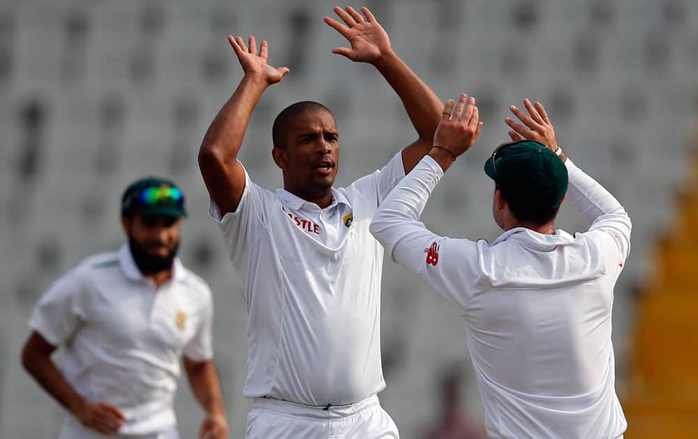South Africa's Vernon Philander celebrates the dismissal of India's Shikhar Dhawan during the first day of their first cricket test match in Mohali.