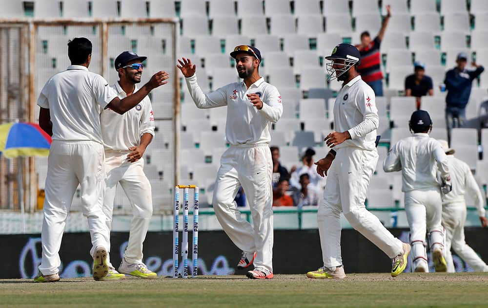 Virat Kohli, celebrates the dismissal of South Africa's Hashim Amla during the second day of their first cricket test match in Mohali.