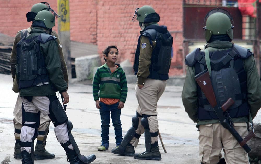 A boy seeking permission from security personnel to move forward during restrictions imposed by to maintain law and order following protest called by separatists ahead of Prime Minister Narendra Modis visit in Srinagar.