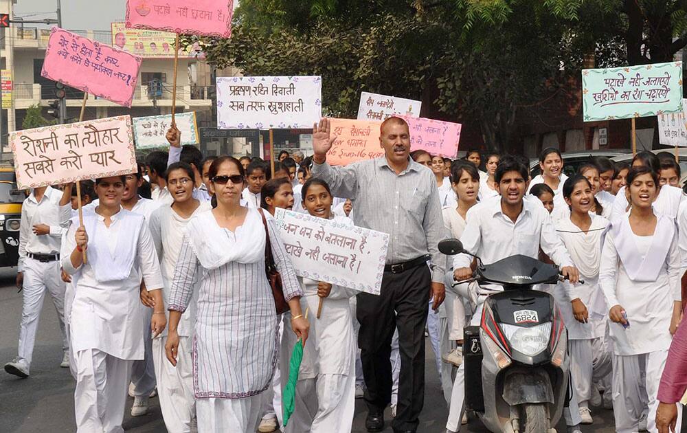 Students of District Institute of Education and Training (DIET) display placards as they participate in a awareness campaign on Diwali in Gurgaon.