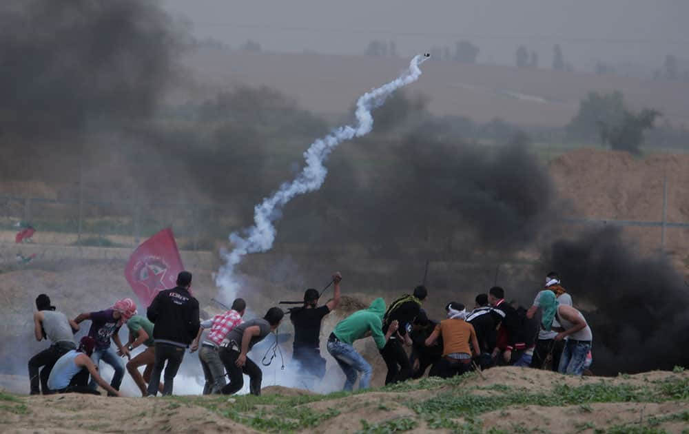 Palestinian protesters clash with Israeli soldiers on the Israeli border with Gaza in Bureij, central Gaza Strip.