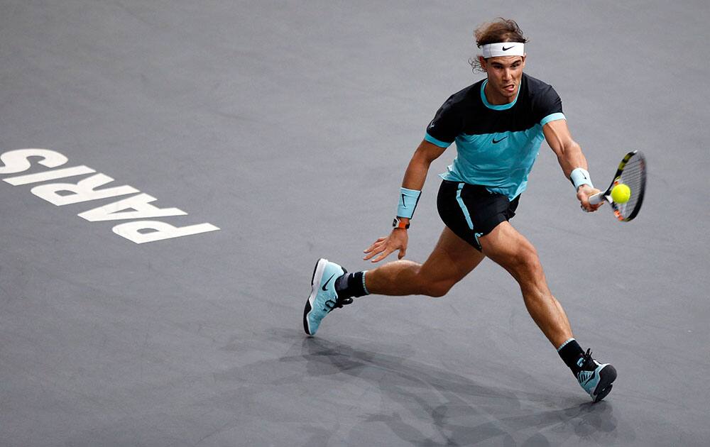 Rafael Nadal of Spain returns the ball to Switzerland's Stan Wawrinka during their quarterfinal match of the BNP Masters tennis tournament, at Bercy Arena, in Paris.