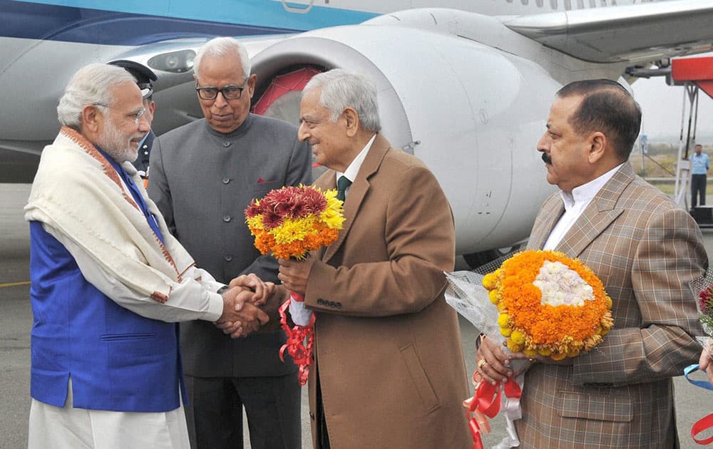 Prime Minister Narendra Modi being received by the Governor of Jammu and Kashmir, NN Vohra, Chief Minister Mufti Mohd Sayeed and MoS at PMO Jitendra Singh on his arrival at the airport in Jammu.