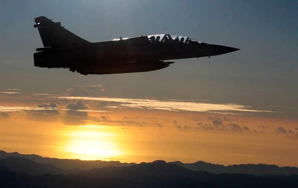 A Taiwan air force jet escorts a plane out of Taiwan airspace carrying Taiwan's President Ma Ying-jeou from Taiwan to Singapore for a meeting with China's President Xi Jinping.