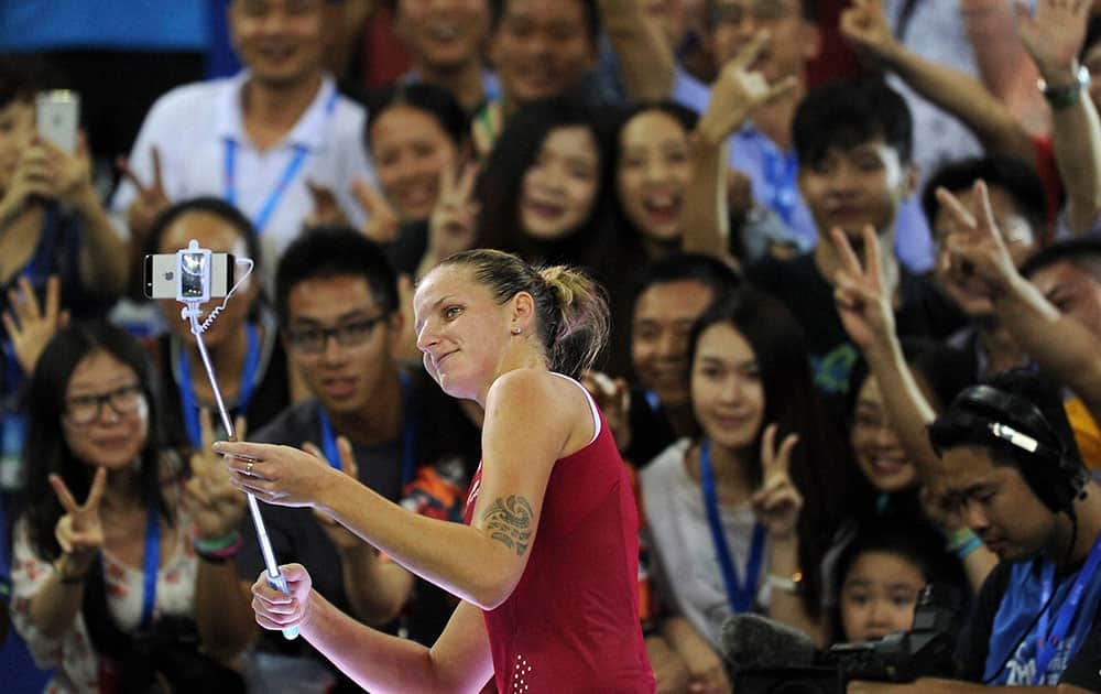 Karolina Pliskova of Czech Republic takes a selfie with spectators after defeating Elina Svitolina of Ukraine during a semi-final match for the 2015 WTA Elite Trophy tennis tournament in Zhuhai in southern Chinas Guangdong province.