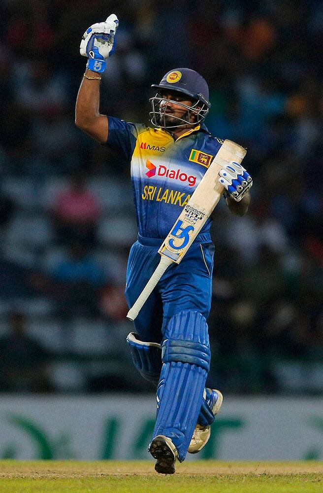 Sri Lankas Kusal Perera celebrates after scoring fifty runs during their third one day international cricket match against West Indies in Pallekele.