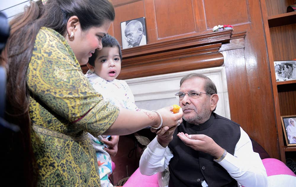 JD(U) President Sharad Yadav is offered sweets by his daughter after the Mahagathbandhans victory in Bihar assembly elections.