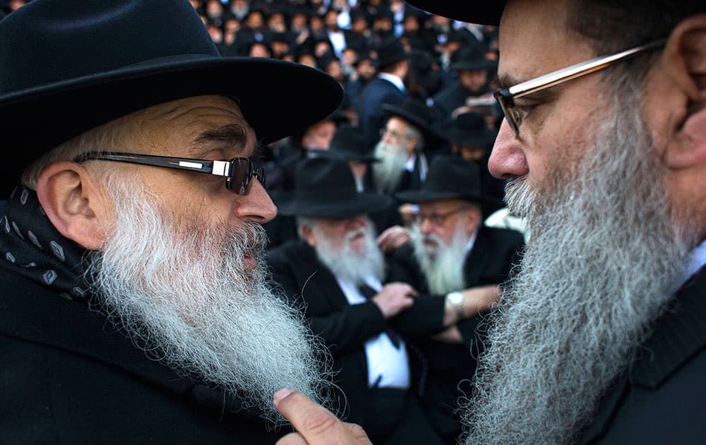 Lubavitch rabbis talk to each other as thousands of them, from 86 countries, gather together for a group photo near Chabad-Lubavitch headquarters in the Brooklyn borough of New York.