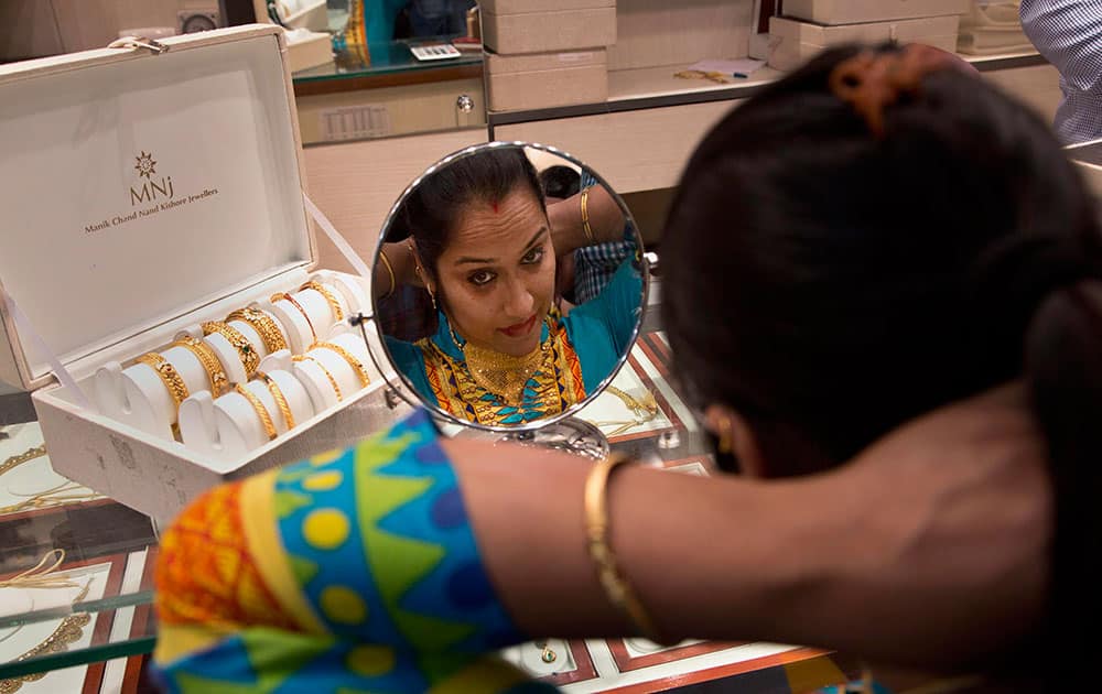 A woman tries a necklace as she shops during Dhanteras festival in Guwahati.