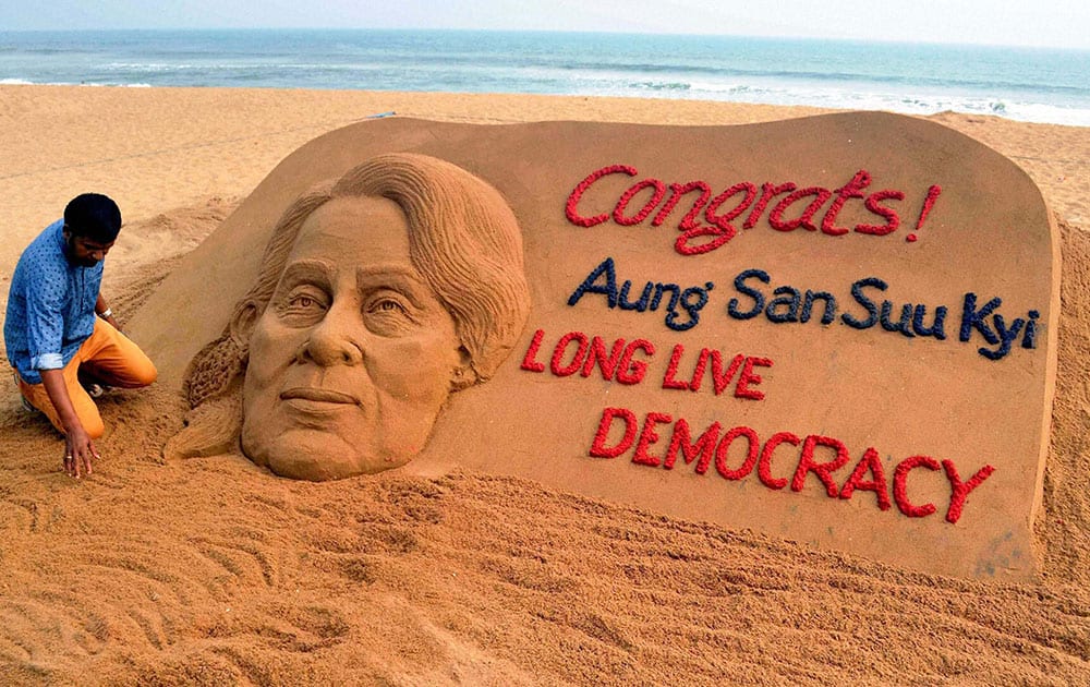 Sand artist Sudarshan Pattnaik creates a sand sculpture with a message Congrats! Aung San Suu Kyi, Long Live Democracy.