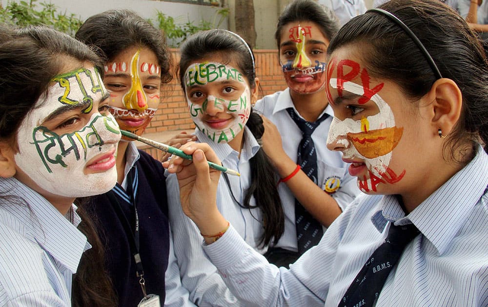 School Children painting their faces during Diwali celebrations at a school.
