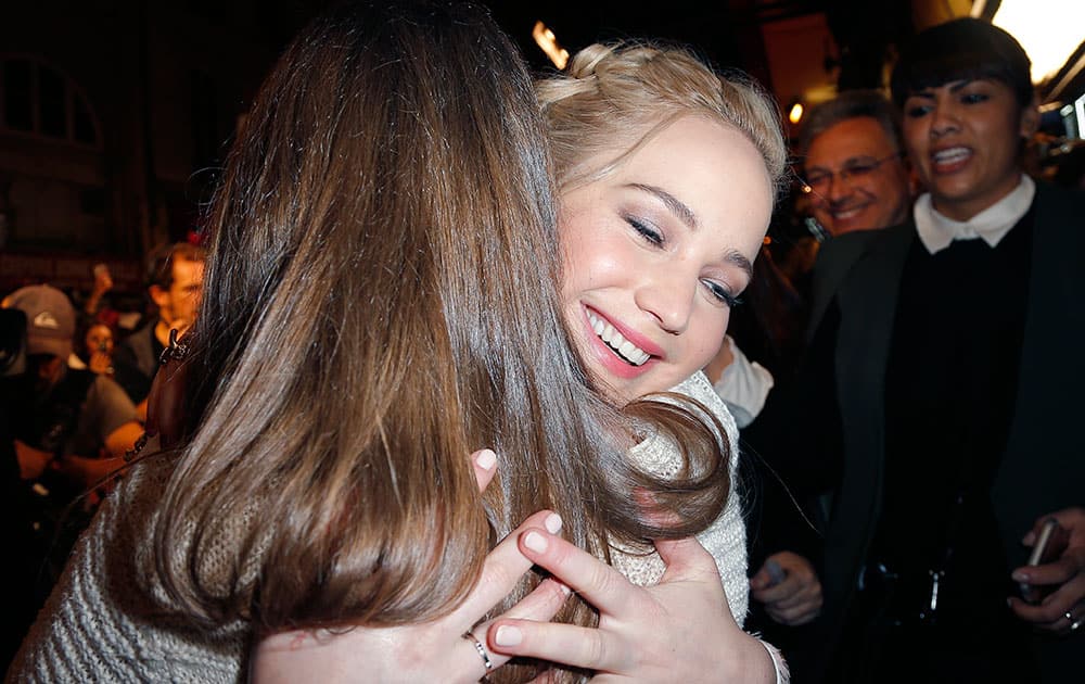 US  actress Jennifer Lawrence embraces a guest on her arrival at the premiere of the film 'The Hunger Games Mockingjay Part 2', in Paris, France.