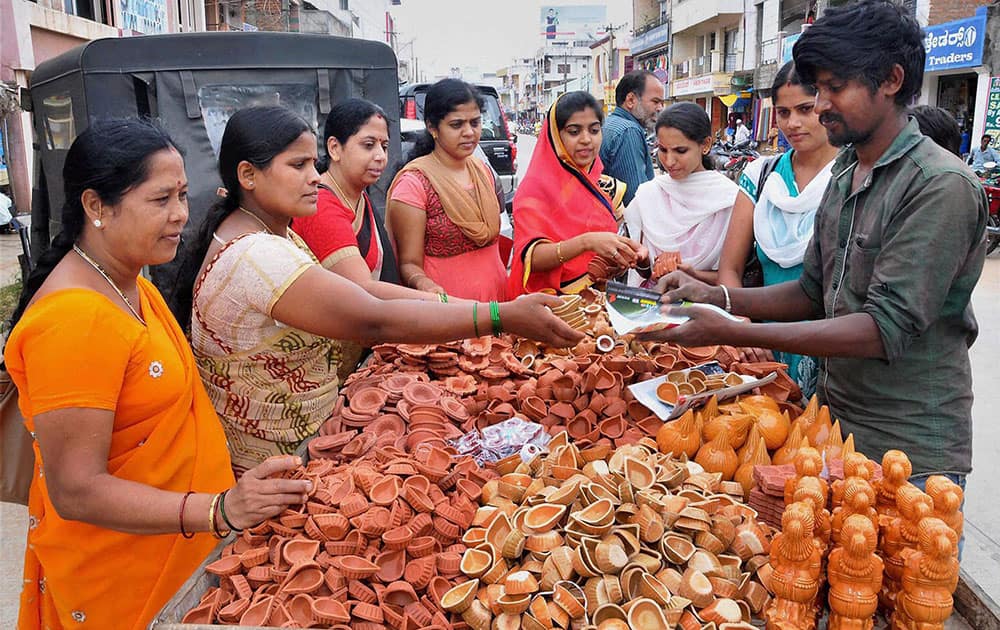 Women buying earthen lamps on ahead of Diwali festival at Chikmagalur in Karnataka.