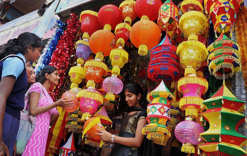 Girls looking at colourful lamps at a shop ahead of Diwali festival at Chikmagalur in Karnataka.