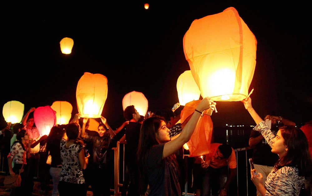 Youngsters release sky lanterns in air during Bhopal Light Festival ahead of Diwali in Bhopal.