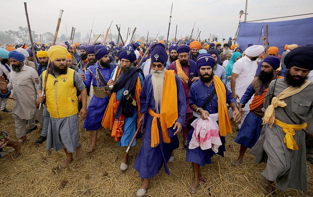 Nihangs arrive to participate in Sarbat Khalsa with their traditional weapons at Chaba village near Amritsar.