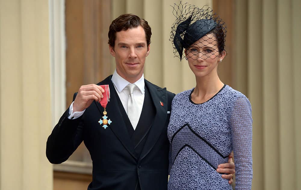 British actor Benedict Cumberbatch, left, poses with his wife Sophie Hunter after receiving the CBE (Commander of the Order of the British Empire) from Britain's Queen Elizabeth II, during an Investiture Ceremony at Buckingham Palace, in London.