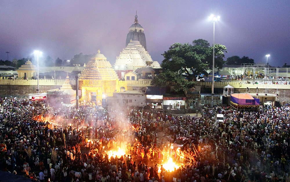 People burning jute sticks outside the Shri Jagannath temple in Puri to pay obeisances to their forefathers on the occasion of Diwali.