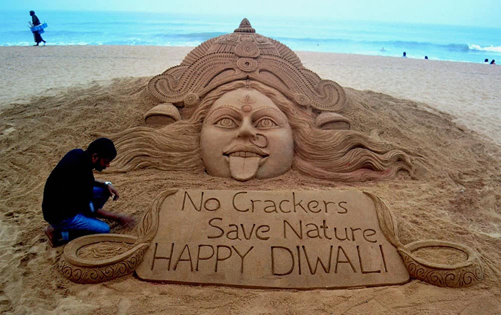 Sand artist Sudarsan Pattnaik creates a sand sculpture of Goddess Kali with message No crackers, Save Nature.