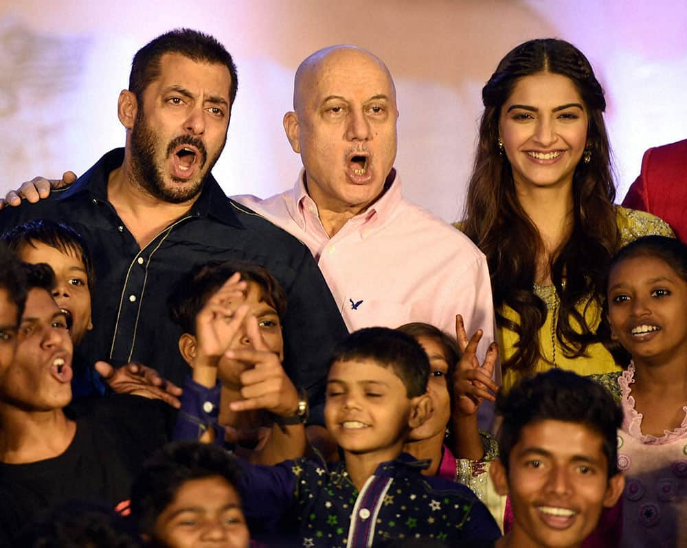 Bollywood actor Salman Khan, Sonam Kapoor and Anupam Kher along with Dharavi Rocks a band of kids who make music out of waste materials during a promotional event in Mumbai.