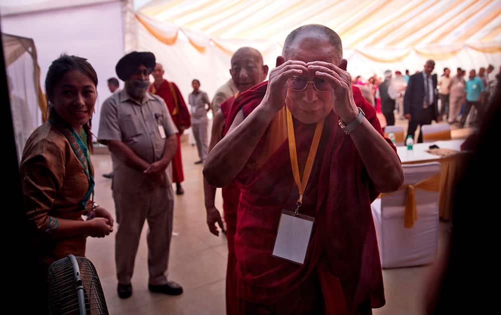 Tibetan spiritual leader the Dalai Lama looks through a window during during a conference on Quantum Physics and Madhyamika Philosophical View in New Delhi, India.